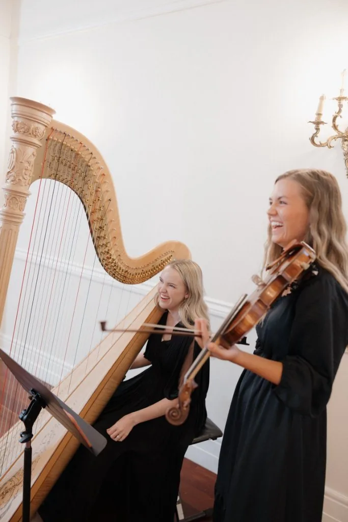 Monet and Eliza laughing while performing